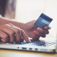 Hands,Holding,Credit,Card,And,Using,Laptop.,Online,Shopping